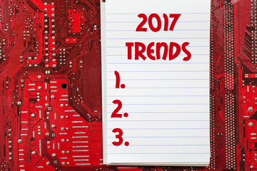 Red old dirty computer circuit board and 2017 trends text concep