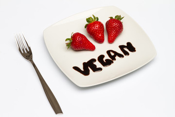 Strawberry in plate with fork isolated