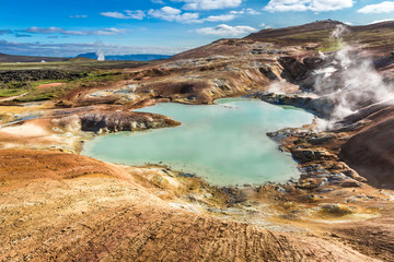 Fototapeta na wymiar Blue pond on volcano area in Iceland in summer