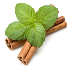 Cinnamon sticks and fresh peppermint herb leaves isolated on whi