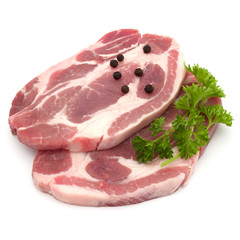 Raw pork neck chop meat with parsley herb leaves and peppercorn