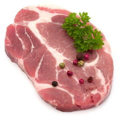 Raw pork neck chop meat with parsley herb leaves and peppercorn
