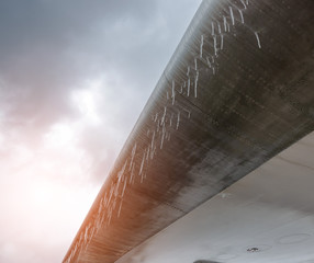icing aircraft wing. Icicles hang from the edge of the wing
