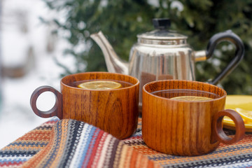 Two cups of tea on a table in the winter garden