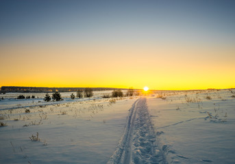 Sunset over snow-covered field