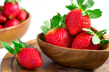 Bowl with juicy garden strawberries closeup