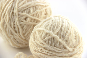Fototapeta na wymiar a group of multi-colored balls of yarn and knitting needles