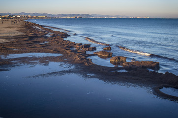 Spanish coast. Malvarrosa beach with people taking a walk, Valencia, Spain