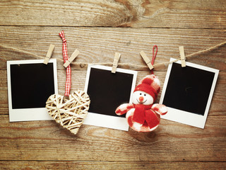 Vintage photo frames decorated for Christmas on the wooden board