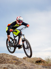 Fototapeta na wymiar Professional Cyclist Riding the Bike Down Rocky Hill. Extreme Sport Concept.
