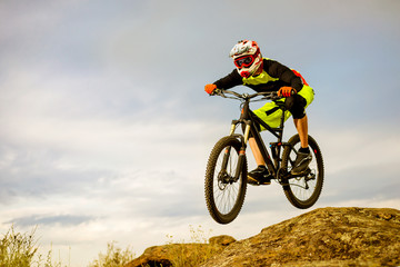 Naklejka premium Professional Cyclist Riding the Bike Down Rocky Hill. Extreme Sport Concept. Space for Text.