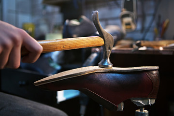 shoemaker makes and repairs shoes for men