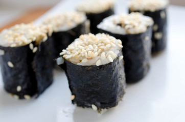 Close up of tasty fresh sushi rolls on plate