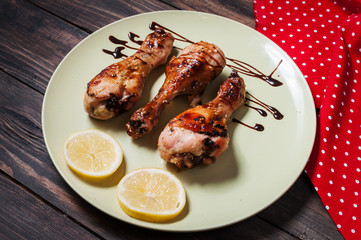chicken legs on plate wood background.