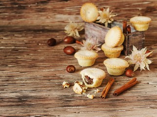 small round Christmas cakes with nuts and cinnamon, space for text