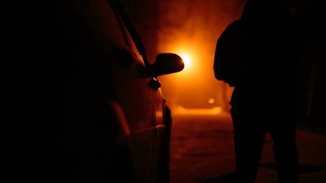 Silhouette terrible zombie night near the car