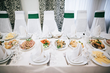 Table set for an event party or wedding reception. Food and drink