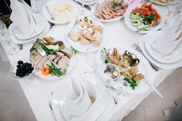 Table set for an event party or wedding reception. Food and drink