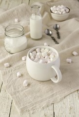 white cup with cocoa and marshmallows, selective focus