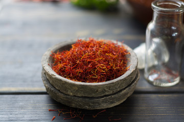 Raw Organic Red Saffron Spice in a clay bowl