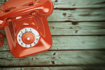 Vintage retro telephone on the wood background.