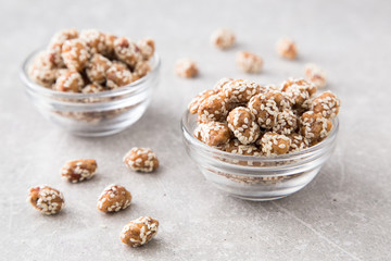 Caramel Coated Peanut with Sesame on Stone Background