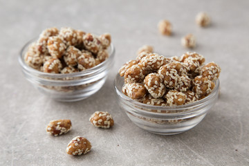 Caramel Coated Peanut with Sesame on Stone Background