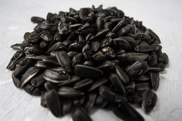 Black sunflower seeds on a white background