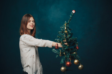 woman with a Christmas tree, holiday toys