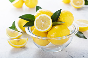 Fresh lemons in a glass bowl