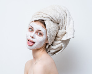  cream on her face, mask on the face, a towel on his head, problem skin