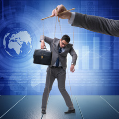 Businessman puppet being manipulated by boss