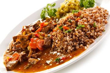 Roasted meat, white grits and vegetables