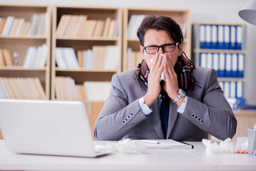 Sick businessman suffering from illness in the office