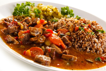 Roasted meat, white grits and vegetables