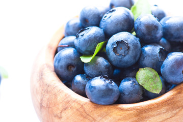 Fresh blueberriaes in wooden bowl.