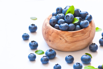 Fresh blueberriaes in wooden bowl.