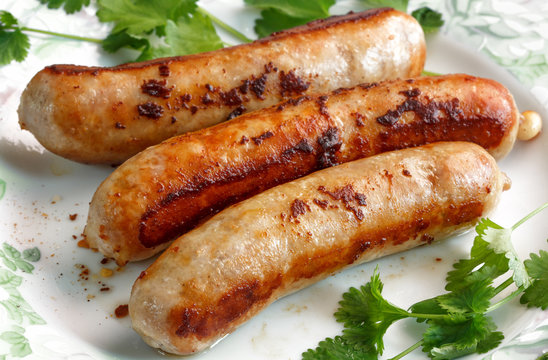 three fried  sausages on a plate