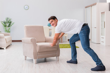 Fototapeta premium Man moving furniture at home