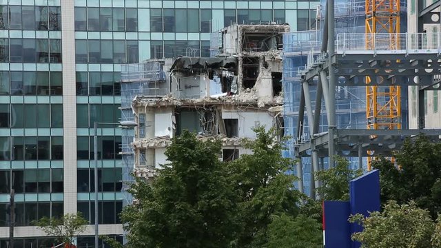 Demolition of an old building and a glass tower in Europe