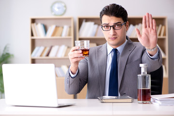 Young businessman drinking from stress