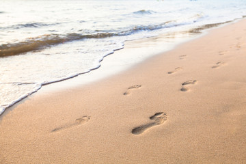Fototapeta na wymiar footprints of couple on the sand of beach