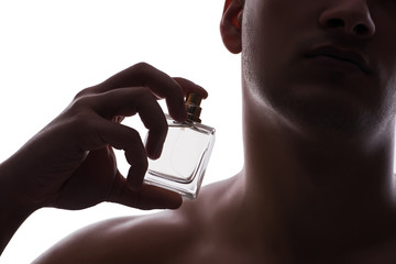 Sexy man with bottle of perfume