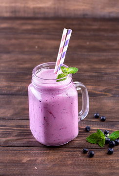 Blueberry smoothie in a glass jar.