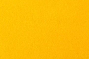 Close up of bright yellow felt fabric. - obrazy, fototapety, plakaty