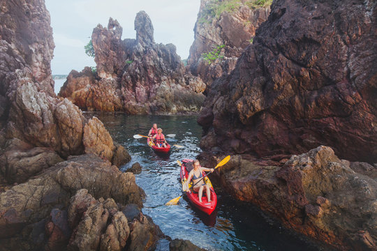 Kayaking, Adventure Travel, Group Of People On Kayaks Between Cliffs