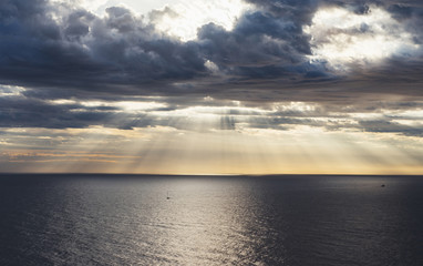 Naklejka na ściany i meble Clouds blue sky and sunlight sunset on horizon ocean . Сloudscape on background seascape dramatic atmosphere rays sunrise. Relax view waves sea with ship, mockup nature evening concept..