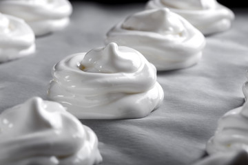 White meringues on baking paper