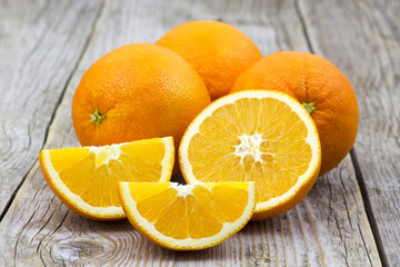 fresh oranges on old wooden background