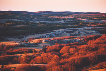 Fototapeta na wymiar Aerial Sunset view of Mountains plateau area with forest natural sunset red colors Travel scenery